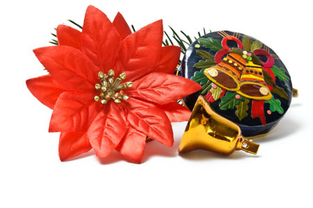 Small closed christmas gift box with bells and fake poinsettia isolated on white