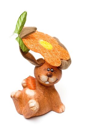 Isolated crazy clay rabbit holding flower and leaf with earsの写真素材