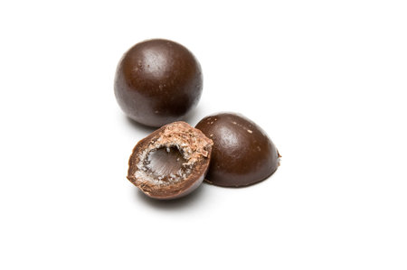 Halved and a whole chocolate ball isolated on whiteの写真素材
