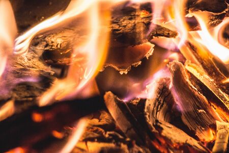 A closeup shot burning wood and the beautiful colors of fireの写真素材