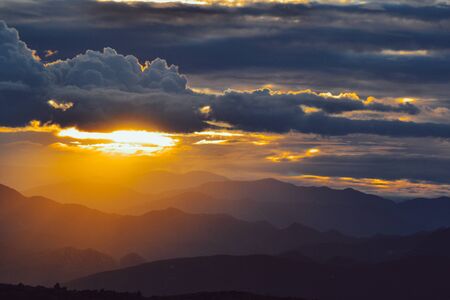 A breathtaking sunset scenery in the dark cloudy sky.の写真素材