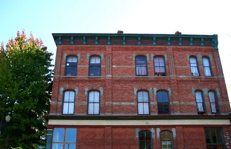Old brick building in city against skyの写真素材