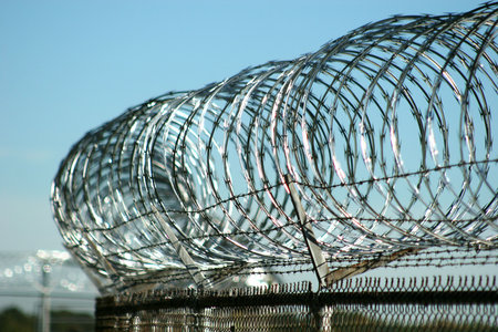 Razor wire atop security fence at military base