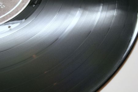 A section of an old vinyl 33 rpm record showing groovesの写真素材