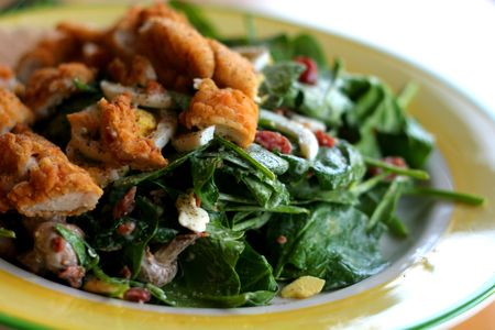 Close up of a green spinach salad with chickent tendersの写真素材
