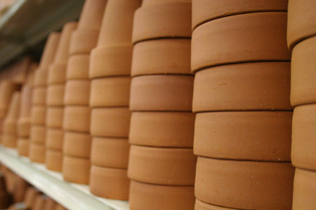 Stacks and rows of clay pots in a retail store