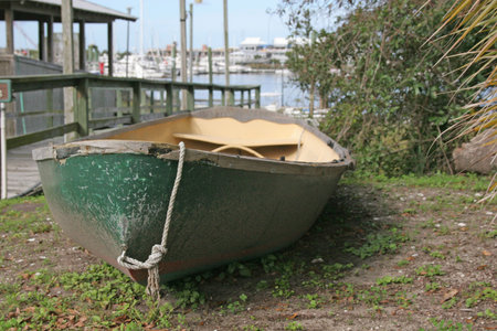 Old green and yellow canoe taken at river dock