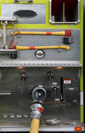 Axes and Hoses attached to a fire truck at a scene