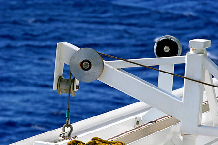 A mechanical pulley on the side of a shipの写真素材