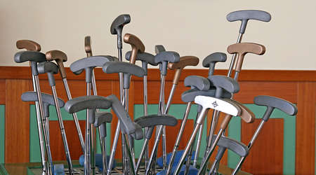 Golf putters sticking out of a rackの写真素材