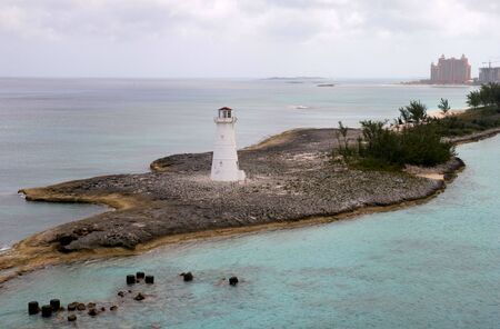 Old lighthouse on a point of landの写真素材