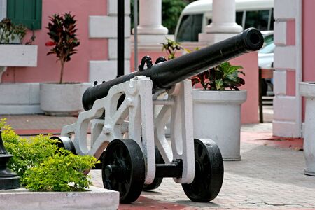 An old cannon sitting in front of a government buildingの写真素材