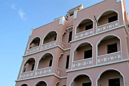 Pink stucco apartment building in tropical areaのeditorial素材