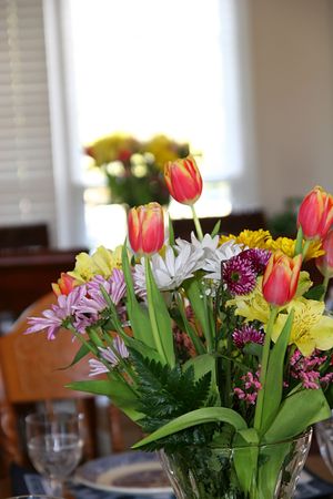 Two bouquets of Easter flowers on dining tablesの写真素材