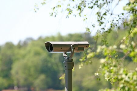 A spotting scope or camera mounted in the woodsの写真素材