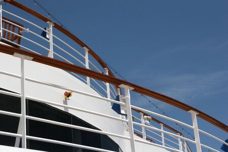 Curved shipboard railings against a blue skyの写真素材
