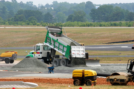 Dump truck dumping gravel on an airport construction site