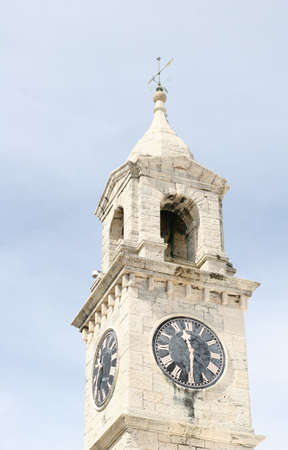 A white stone clock tower at an old British outpostの写真素材