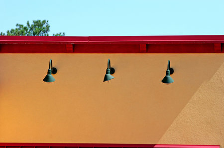 Green lights on a bright yellow and red wall