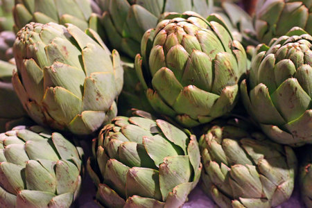 Fresh green artichokes at a vegetable marketの写真素材