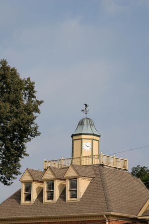 A building roofline and clock in morning sunの写真素材