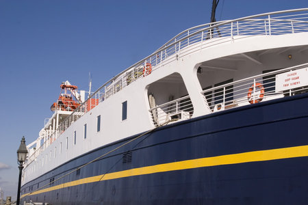 A small blue and yellow passenger ship