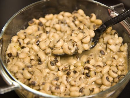 A bowl of blackeyed peas with spoonの写真素材