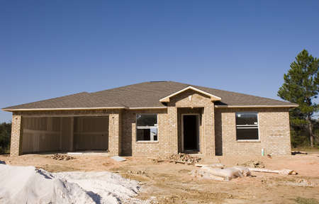 New brick house under construction with sand pile in frontの写真素材