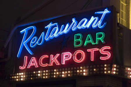 A neon sign outside of a restaurant and casino