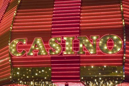 A casino sign in red neon and light bulbsの写真素材