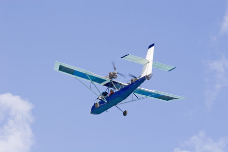A small rear prop plane flying against the sky