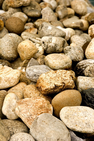 A background of colored rocks on the banks of a river