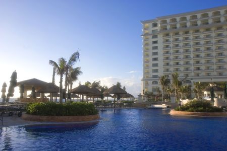 A large blue lagoon type pool at an oceanside resort hotelの写真素材