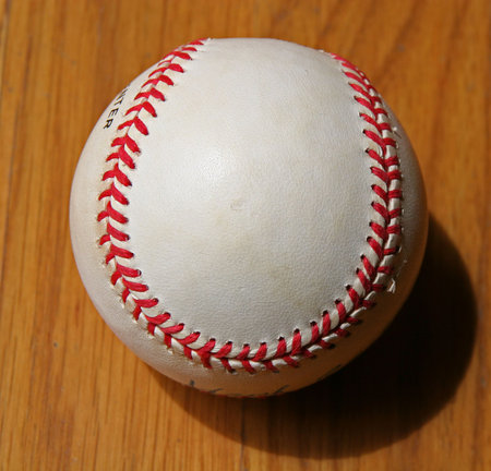 A slightly Worn baseball on wood backgroundの写真素材