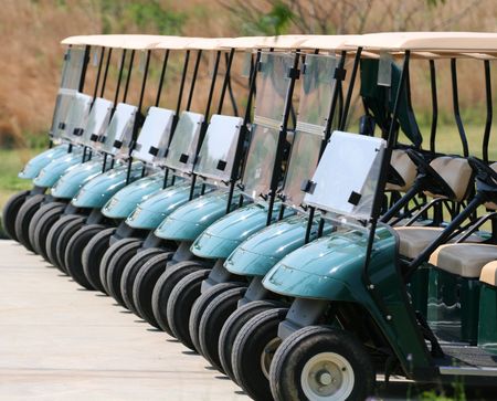 A row of empty golf carts at a courseの写真素材