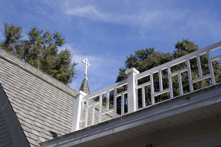 An old church roof with steeple and widows walkの写真素材