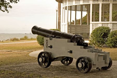 A cannon pointing out to sea at a beach side parkの写真素材
