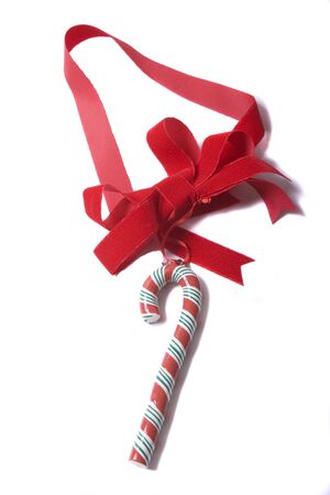 A colorful Candy Cane on a Red Ribbon against a white backgroundの写真素材