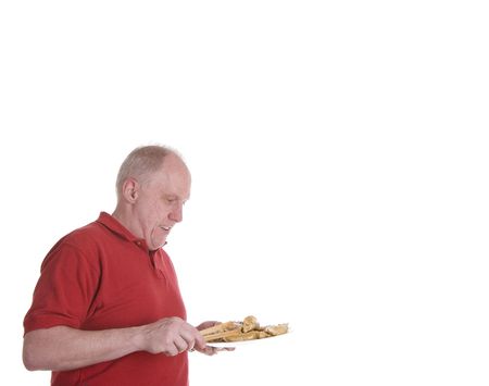 An old guy in a red shirt with a plate of chinese appetizersの写真素材