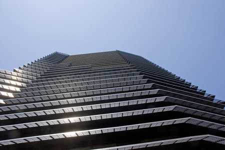 A modern black office tower rising up into the sky