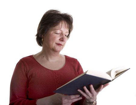 A woman in red on a white background reading a bookの写真素材