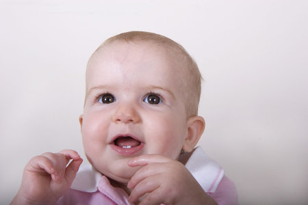 A one year old baby with a happy expressionの写真素材