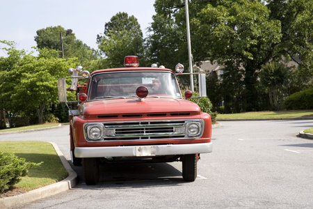 An old vintage fire truck in a parking lot