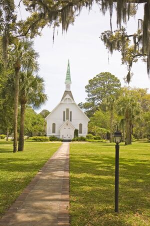 An old small church through southern oaks draped with spanish mossの写真素材