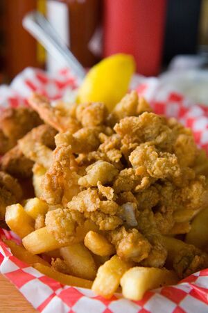 A lunch basket of fried seafood and french friesの写真素材