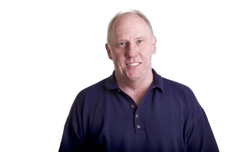 A nice older bald man smiling in a blue shirtの写真素材
