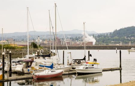 An old fishing dock in front of a cityの写真素材