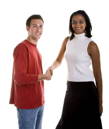 A nicely dressed Indian woman shaking hands with a casual caucasianの写真素材