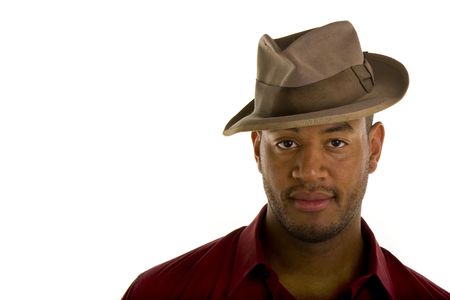 A black man in a red shirt and an old brown hatの写真素材
