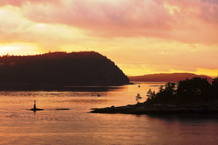 Pilot boats and navigation beacons in a the dawn lightの写真素材